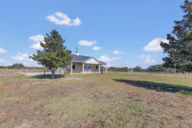 view of yard featuring a rural view and a porch