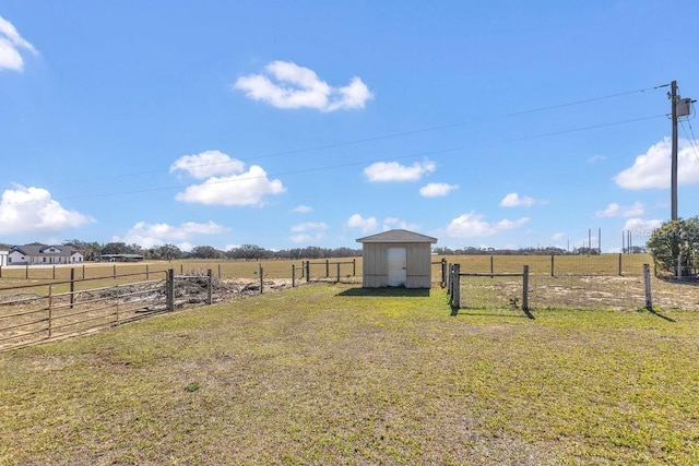 view of yard with a storage unit and a rural view