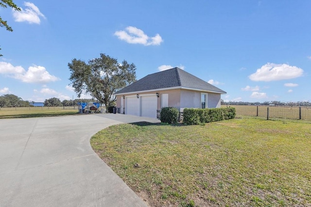 view of side of home with a garage and a lawn