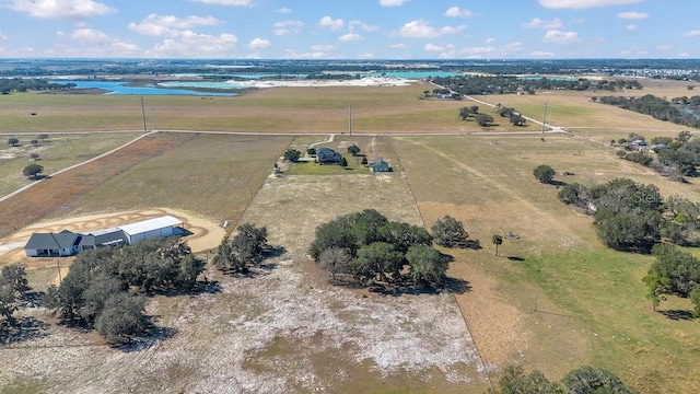 birds eye view of property with a water view and a rural view