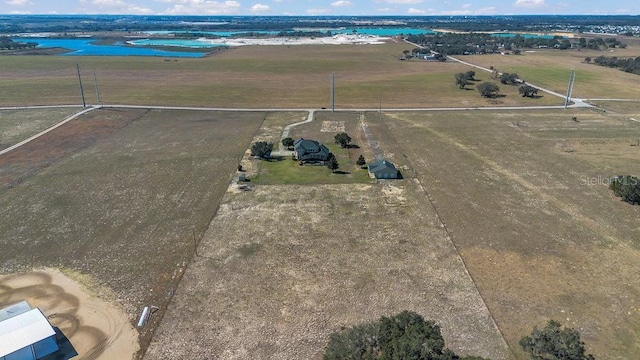 bird's eye view with a water view and a rural view