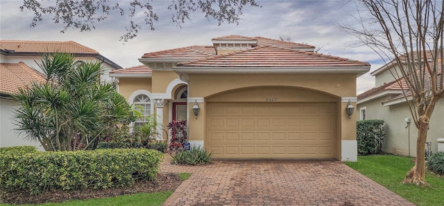 mediterranean / spanish home featuring a garage