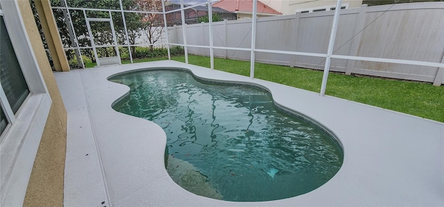 view of pool featuring a lawn and a patio area