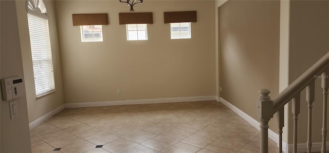 tiled empty room with a healthy amount of sunlight