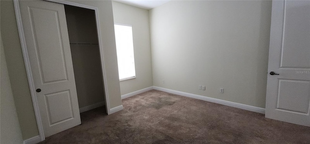 unfurnished bedroom with a closet and carpet