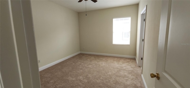 empty room with light colored carpet and ceiling fan