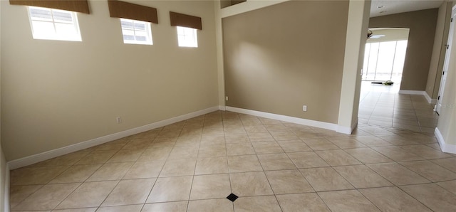 tiled empty room with a healthy amount of sunlight