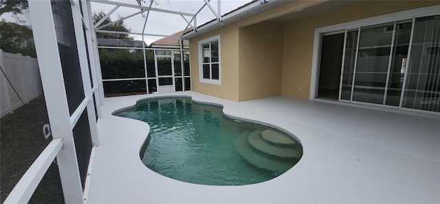 view of pool featuring a lanai and a patio