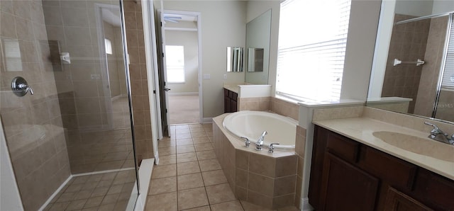 bathroom with tile patterned flooring, vanity, and plus walk in shower