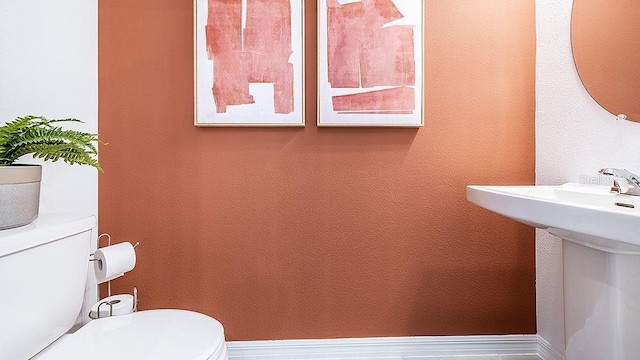 bathroom featuring sink and toilet