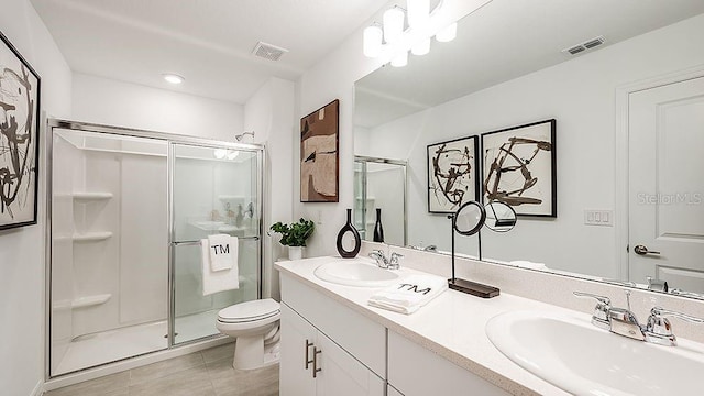 bathroom featuring vanity, tile patterned floors, toilet, and walk in shower