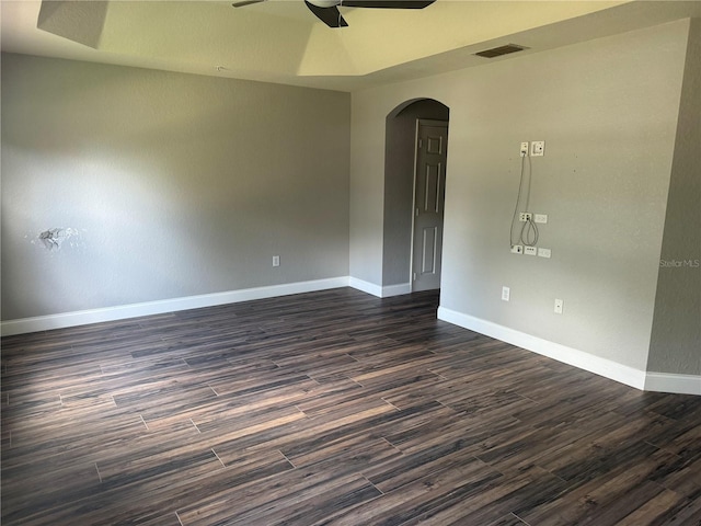 spare room with dark wood-type flooring and ceiling fan