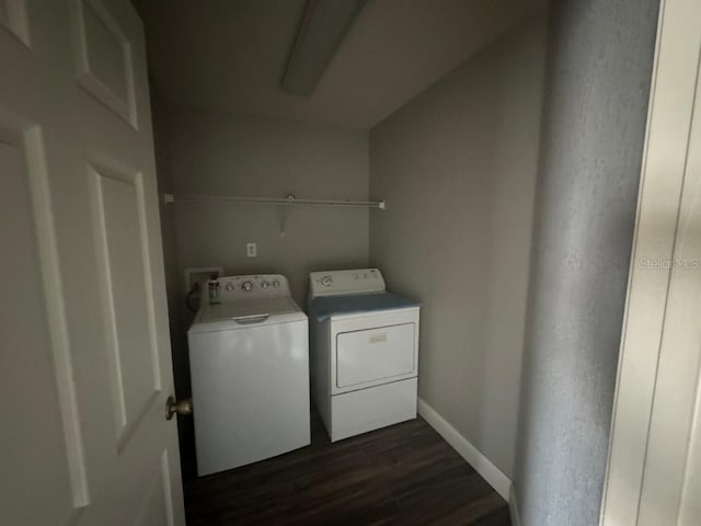 laundry area featuring dark hardwood / wood-style floors and independent washer and dryer