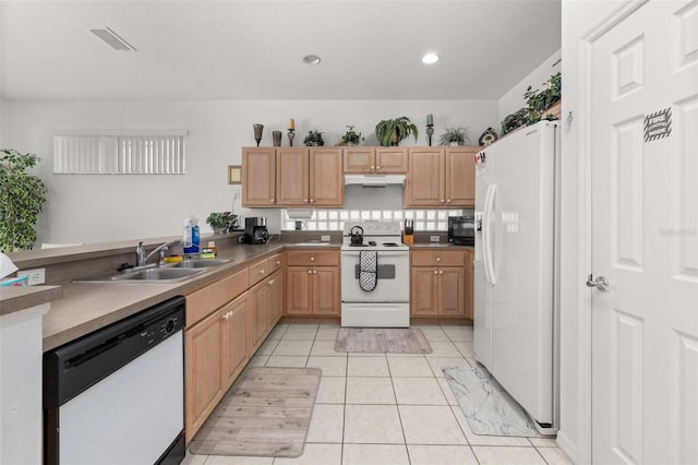 kitchen featuring sink, white appliances, light tile patterned floors, and light brown cabinets