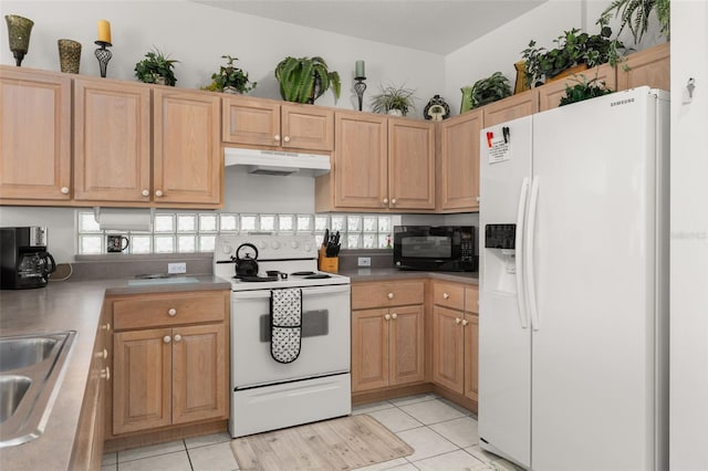 kitchen featuring sink, white appliances, a wealth of natural light, and light tile patterned flooring