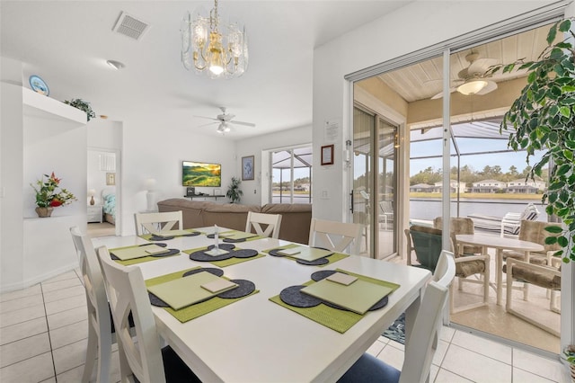 dining room featuring light tile patterned flooring and ceiling fan with notable chandelier