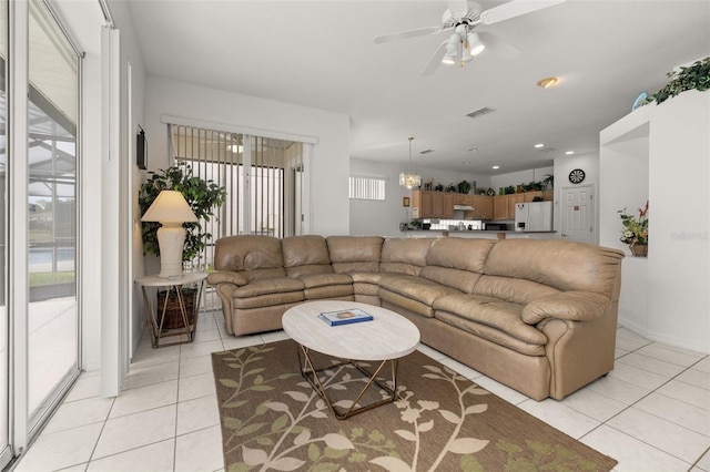 living room featuring light tile patterned floors and ceiling fan