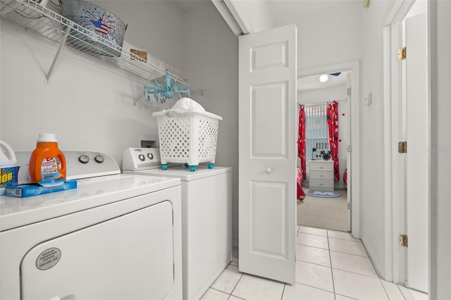 laundry room featuring light tile patterned flooring and washing machine and dryer