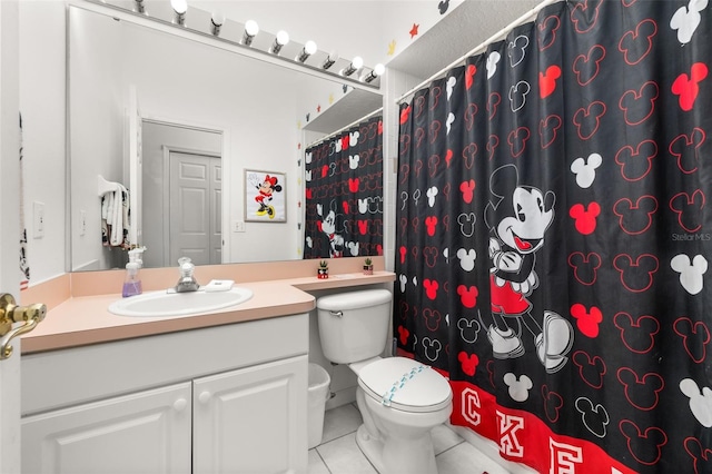 bathroom with vanity, tile patterned floors, and toilet