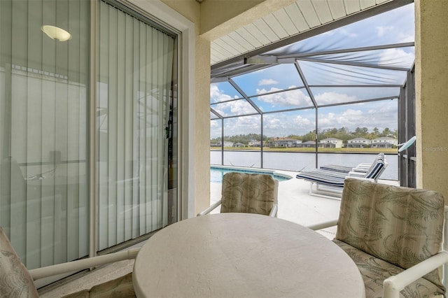 sunroom / solarium with a water view