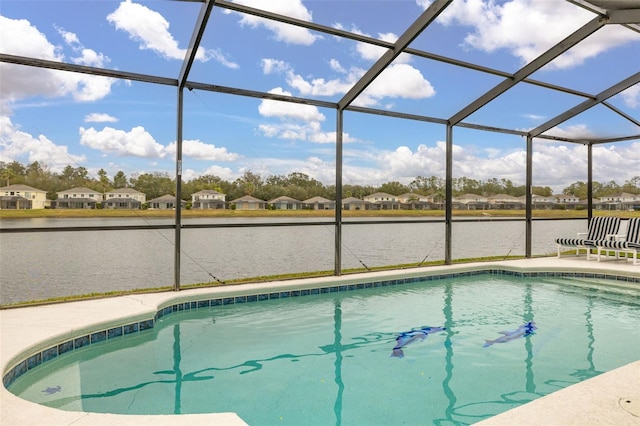 view of swimming pool featuring a water view and glass enclosure