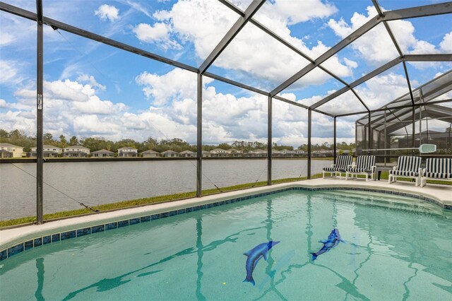 view of pool with a water view and glass enclosure