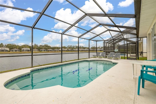 view of pool with a patio, a water view, and glass enclosure