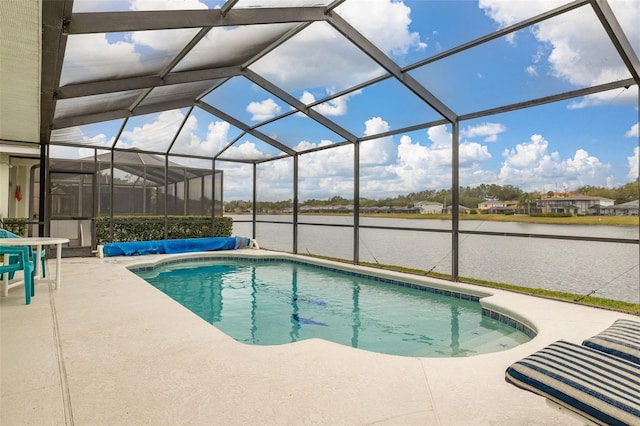 view of swimming pool with a patio, a water view, and glass enclosure