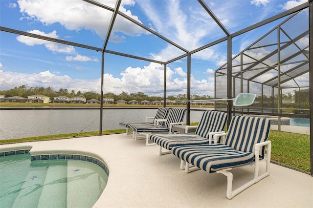 view of swimming pool featuring a patio, a water view, and glass enclosure