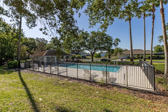 view of swimming pool featuring a patio and a lawn