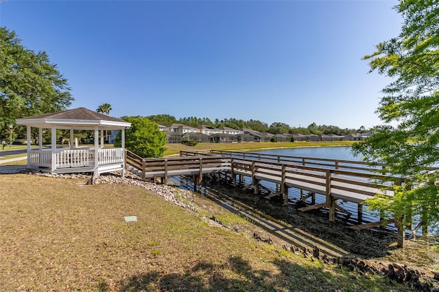 view of dock featuring a gazebo and a water view