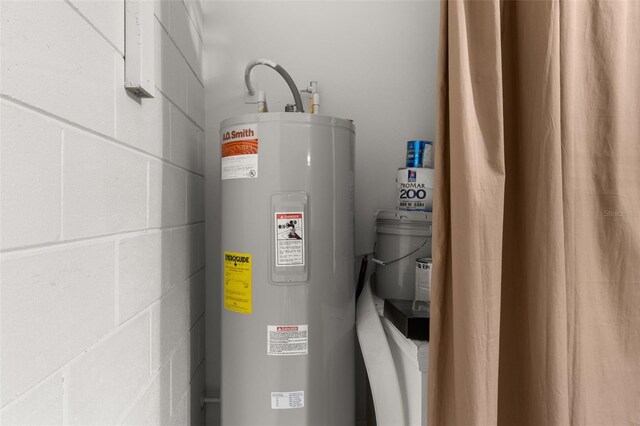 utility room featuring electric water heater