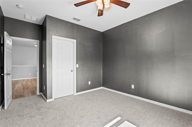 unfurnished bedroom with light carpet and ceiling fan