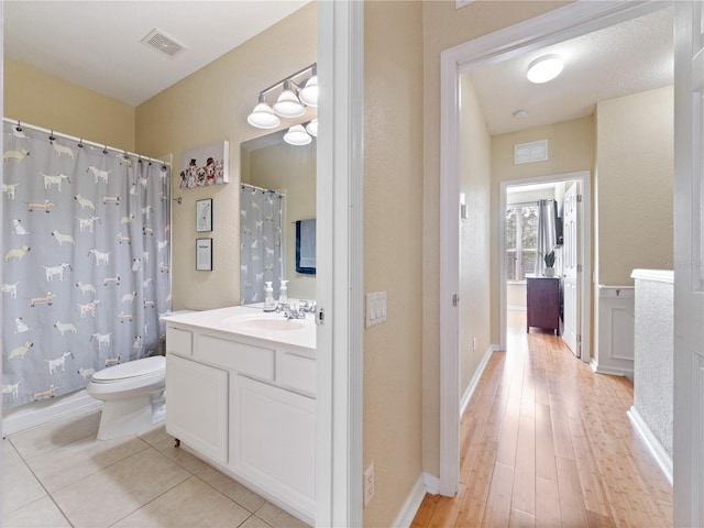 bathroom with tile patterned floors, vanity, and toilet