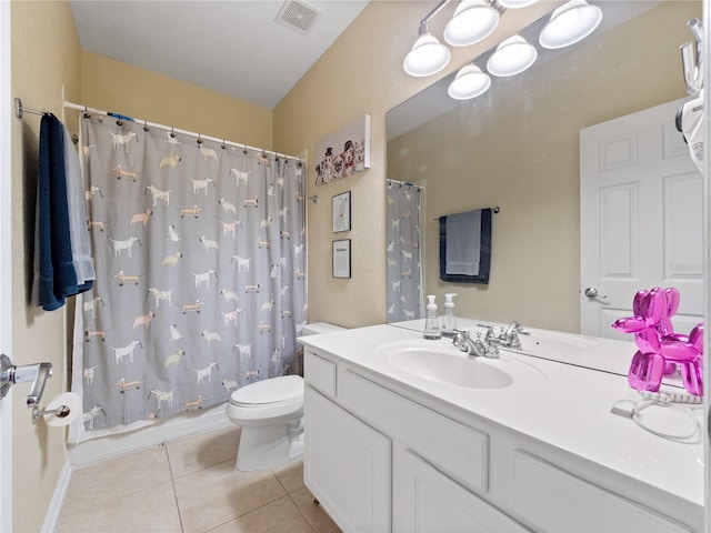 bathroom featuring tile patterned floors, toilet, and vanity