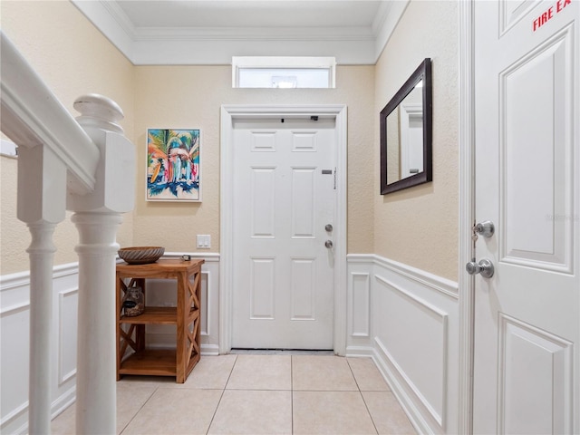 doorway to outside featuring ornamental molding and light tile patterned floors