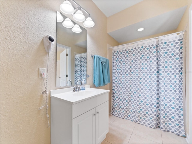 bathroom featuring walk in shower, tile patterned floors, and vanity