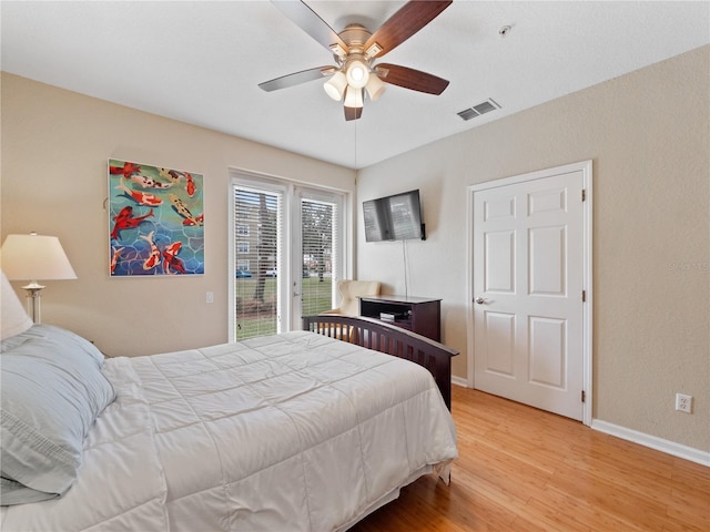 bedroom featuring ceiling fan, light hardwood / wood-style floors, and access to outside