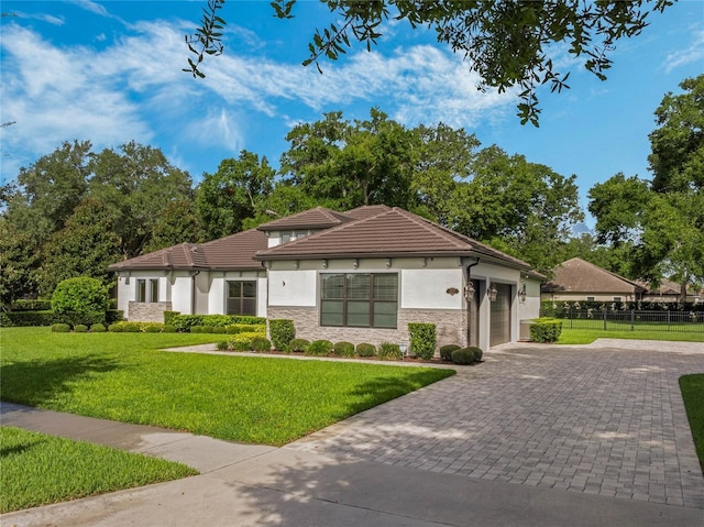 view of front of property featuring a garage and a front yard