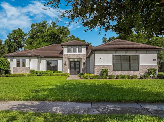 view of front facade featuring french doors and a front lawn