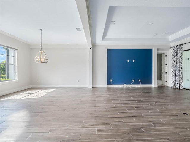 unfurnished living room with an inviting chandelier and ornamental molding