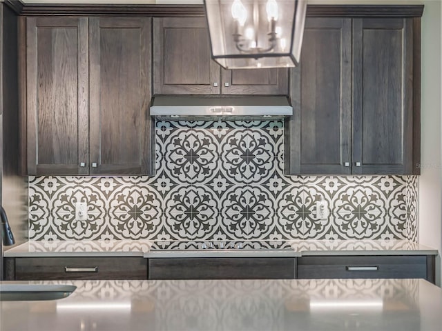 kitchen with dark brown cabinets and exhaust hood