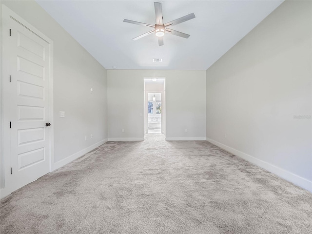 empty room with carpet, lofted ceiling, and ceiling fan