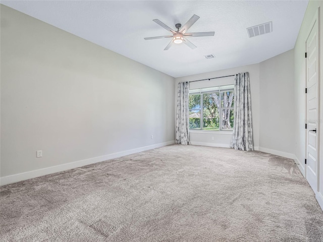 spare room with a textured ceiling, ceiling fan, and carpet flooring