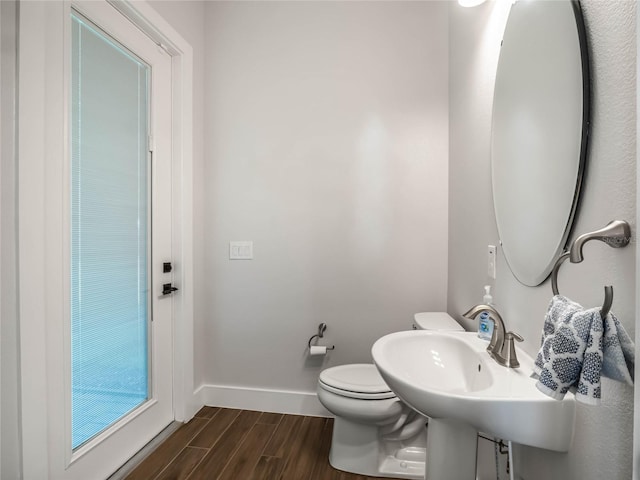 bathroom featuring hardwood / wood-style flooring and toilet