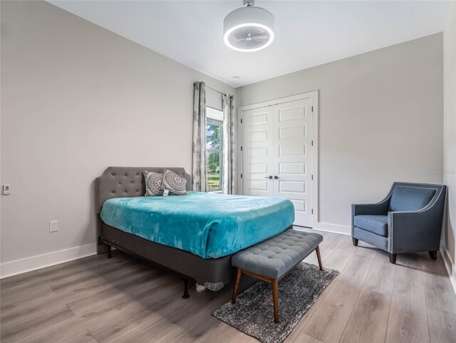 bedroom with hardwood / wood-style flooring and a closet