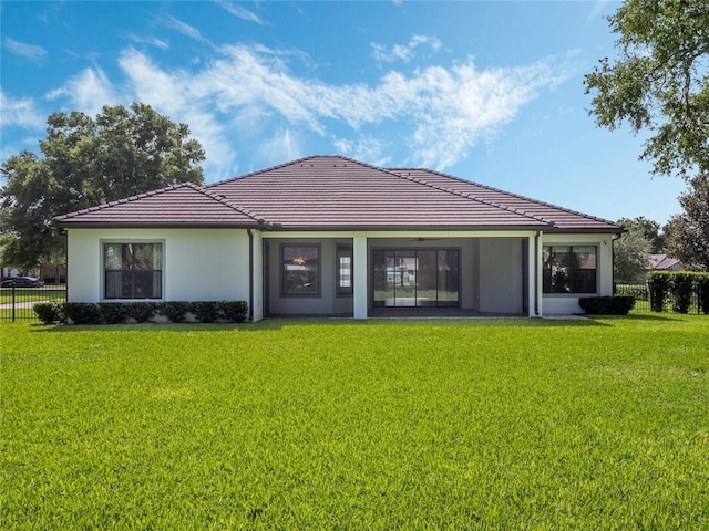 rear view of house with a lawn