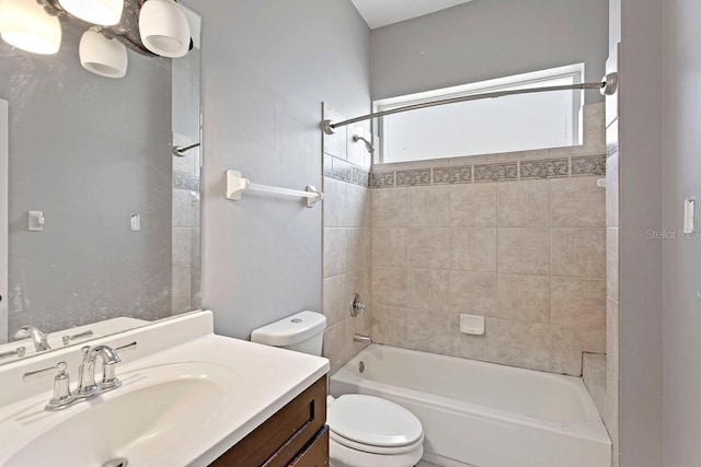 bathroom with toilet, tub / shower combination, and vanity