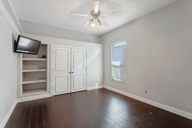 unfurnished bedroom featuring ceiling fan, baseboards, and wood finished floors