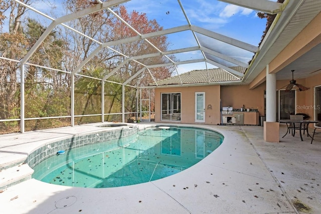 pool featuring ceiling fan, a patio, exterior kitchen, and a lanai